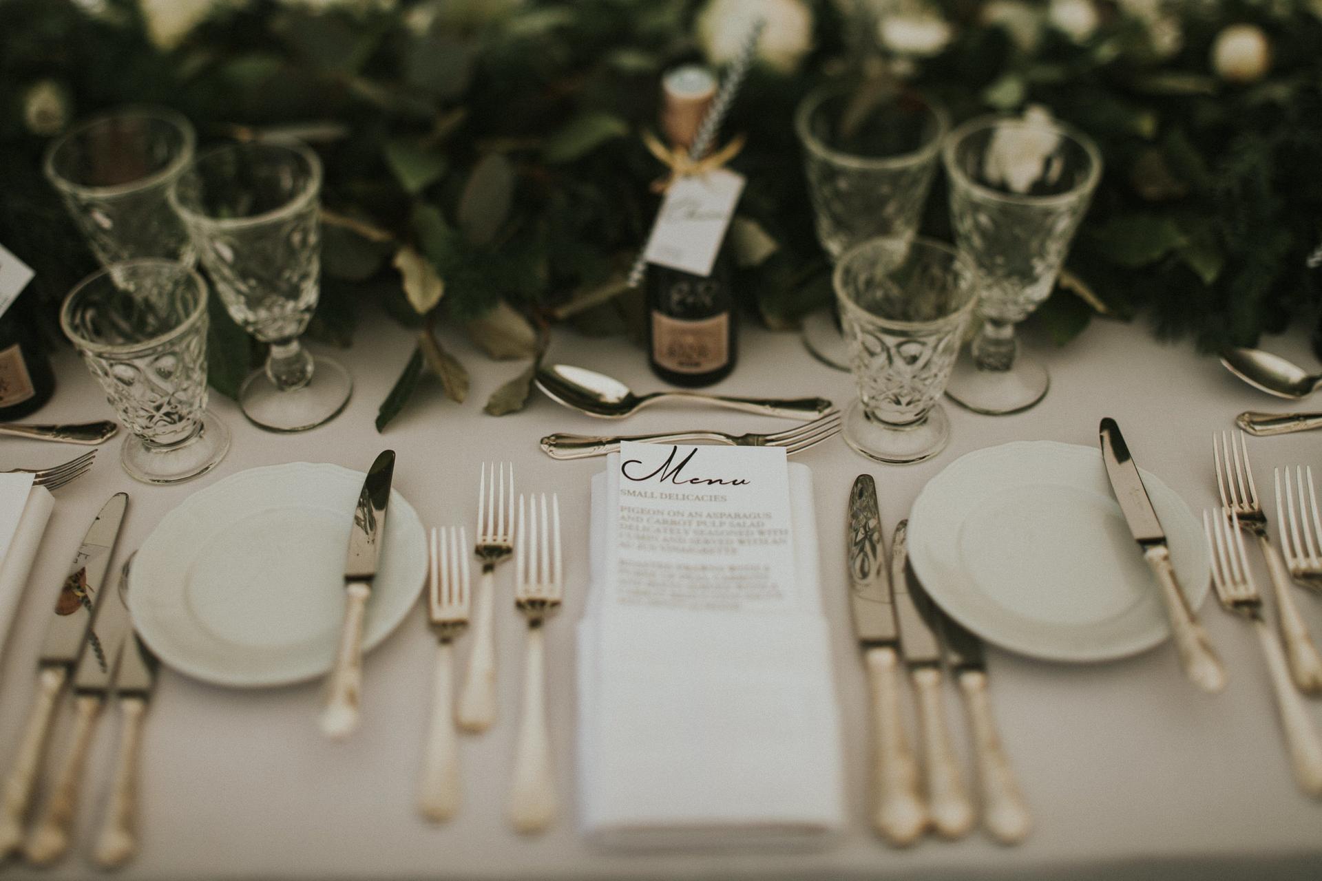 Wedding table with tableware, menu, and glasses